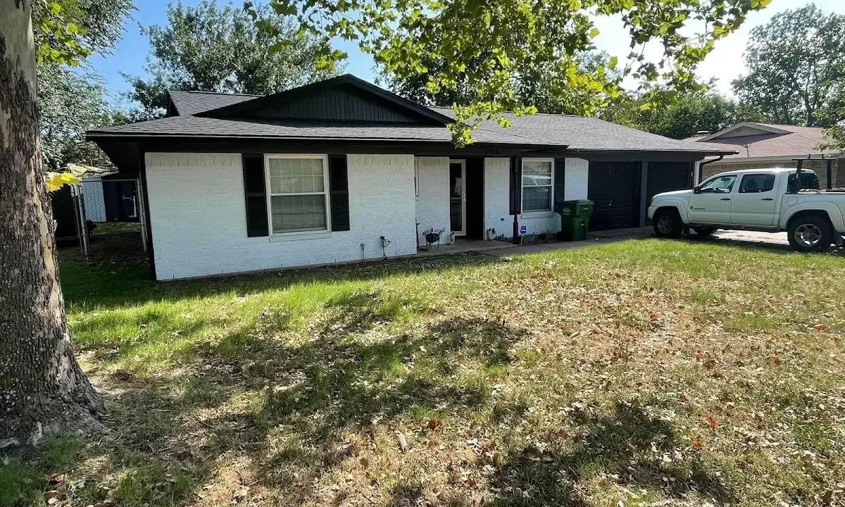 Professional roofing crew working on a residential roof in Coweta